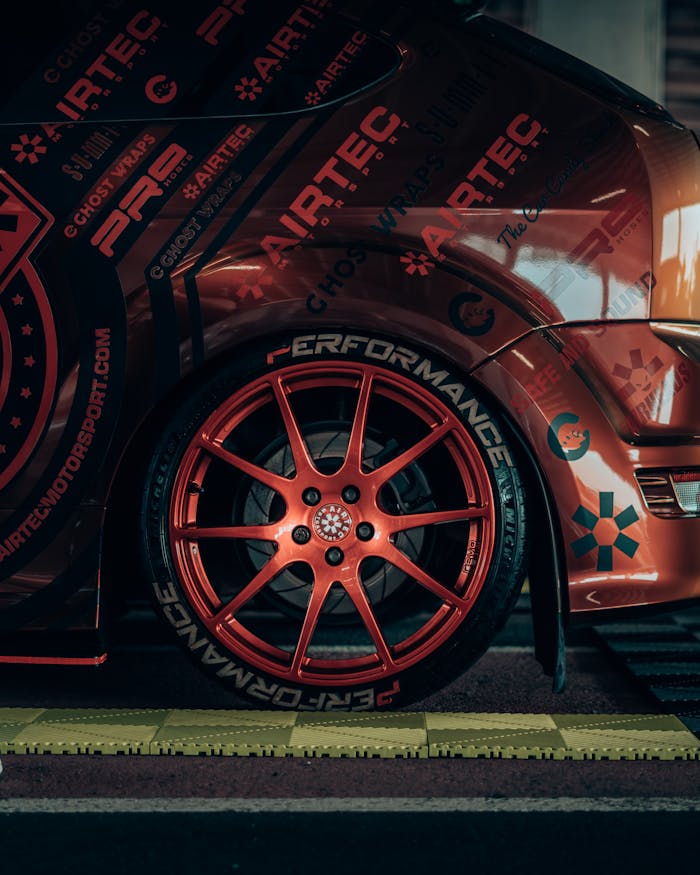 A close up of a car with red rims